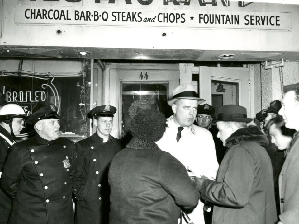 Lt. John Donovan talks to reporters at the scene of a murder in January 1964.