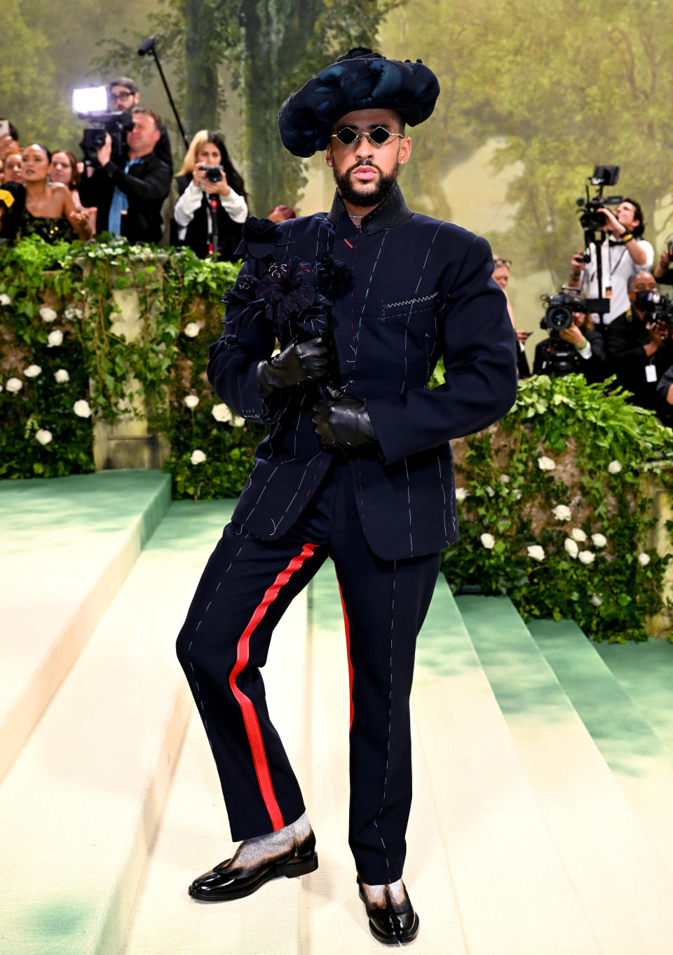 Bad Bunny standing on the steps of the Met at the 2024 Met Gala