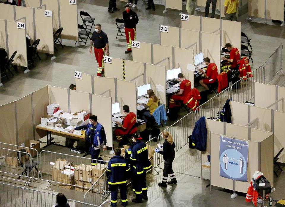 25 vaccination lanes with 30 registration counters are available to those wishing to be vaccinated in the Koenig-Pilsener-Arena in Oberhausen, Germany, Sunday, Dec. 19, 2021. Both first and second vaccinations as well as booster vaccinations are possible. The up to 5,000 visitors will receive either the vaccine from Biontech or from Moderna. (Roland Weihrauch/dpa via AP)