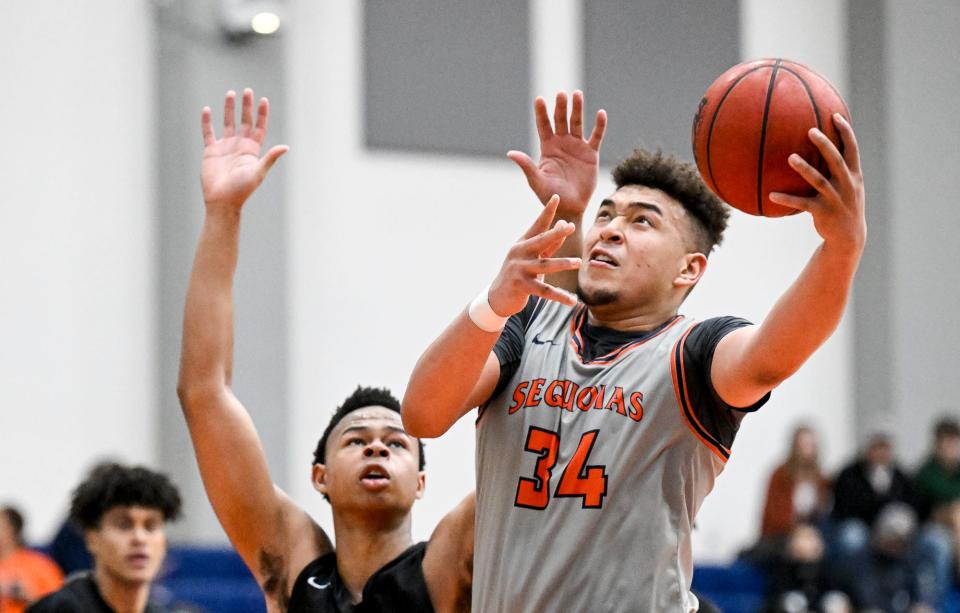 College of the Sequoias' Terri Miller shoots under pressure from Reedley's Justin Parks in men's basketball on Wednesday, February 9, 2022. 