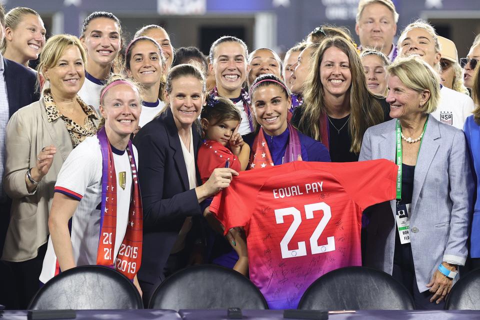 Members of U.S. Soccer, the U.S. Women's National Team Players Association and other dignitaries pose for a photo after signing a collective bargaining agreement signifying equal pay between the men's and women's national soccer teams at Audi Field on Sep. 6, 2022 in Washington, D.C.