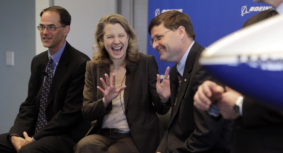 Elizabeth Lund, vice president and general manager of the 747 program, center, shares a laugh during a news conference with Steve Taylor, president of Boeing Business Jets, right, and Bruce Dickinson, vice president and chief project engineer for the 747-8 during a news conference about the first delivery of the Boeing 747-8 Intercontinental jet Tuesday, Feb. 28, 2012, in Everett, Wash. The airplane was scheduled to fly away from Paine Field there later in the day. The new 747-8 Intercontinental is expected to deliver double-digit gains in fuel efficiency over the 747-400 and provide VIP customers and passenger airlines, such as Lufthansa, with the lowest operating costs and best economics of any airplane in its class. Lufthansa is scheduled to take delivery of its first 747-8 Intercontinental early this year. (AP Photo/Elaine Thompson)