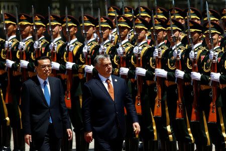 Chinese Premier Li Keqiang and Hungarian Prime Minister Viktor Orban attend a welcoming ceremony at the Great Hall of the People in Beijing, China, May 13, 2017. REUTERS/Thomas Peter