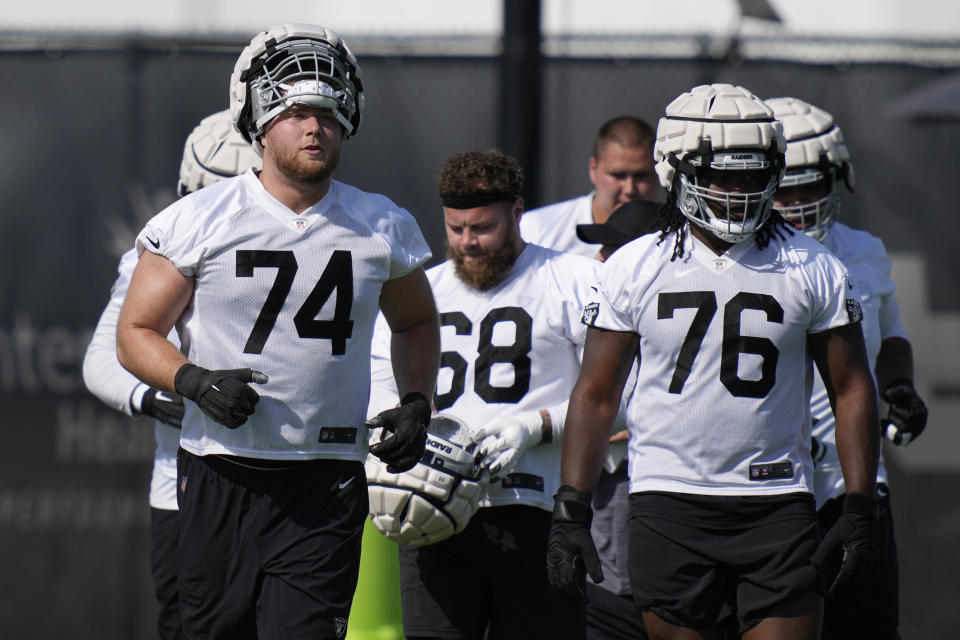 Las Vegas Raiders' Kolton Miller, left, practices during NFL football training camp, Friday, July 22, 2022, in Henderson, Nev. (AP Photo/John Locher)