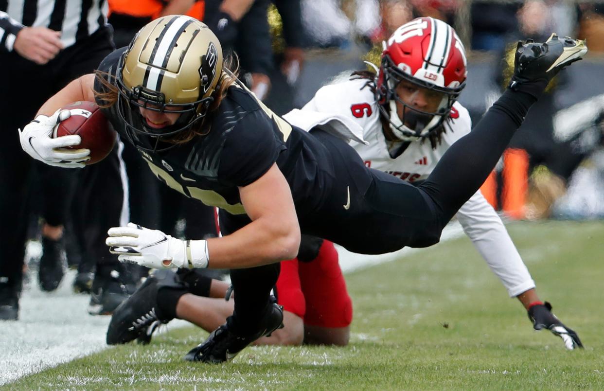 Purdue Boilermakers tight end George Burhenn (81) is tackled by Indiana Hoosiers defensive back Phillip Dunnam (6) during the NCAA football game, Saturday, Nov. 25, 2023, at Ross-Ade Stadium in West Lafayette, Ind.