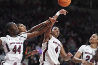 South Carolina forward Aliyah Boston (4), Saniya Rivers (44), and LeLe Grissett (24) battle for a rebound against Maryland forward Angel Reese (10) during the first half of an NCAA college basketball game Sunday, Dec. 12, 2021, in Columbia, S.C. (AP Photo/Sean Rayford)