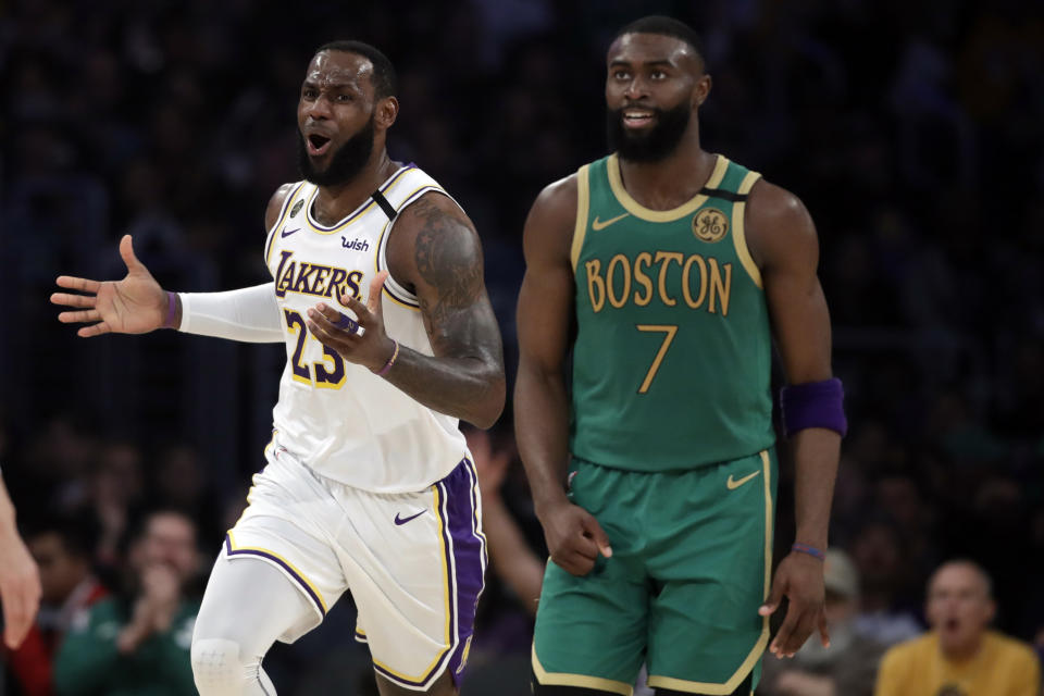 Los Angeles Lakers' LeBron James (23) argues a call next to Boston Celtics' Jaylen Brown (7) during the first half of an NBA basketball game Sunday, Feb. 23, 2020, in Los Angeles. (AP Photo/Marcio Jose Sanchez)