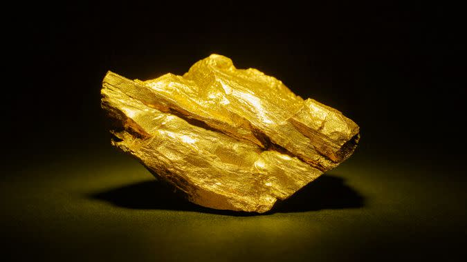 Closeup of big gold nugget on a black background.