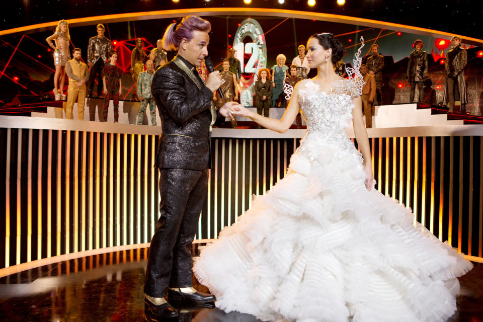 Katniss in the wedding dress Cinna made her with caesar onstage