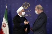 FILE - In this July 4, 2020, file photo released by the official website of the office of the Iranian Presidency, President Hassan Rouhani, left, talks with his Minister of Health and Medical Education Saeed Namaki during a meeting in Tehran, Iran. As coronavirus infections reached new heights in Iran, overwhelming its hospitals and driving up its death toll, the country’s health minister gave a rare speech criticizing his own government’s refusal to enforce basic health measures. (Iranian Presidency Office via AP, File)