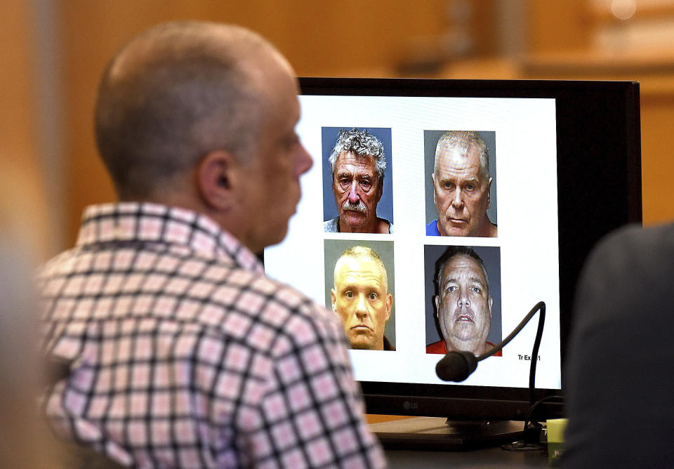 Plaintiff David Meehan listens to testimony of Michael Gilpatrick, a former youth detention center resident, during a civil trial seeking to hold the state accountable for alleged abuse at the Sununu Youth Services Center, formerly called the Youth Development Center, Wednesday, April 17, 2024, at Rockingham County Superior Court in Brentwood, N.H. On the screen is so called "hit squad" members including Bradley Asbury, clockwise from to left, James Woodlock, Stephen Murphy and Jeffrey Buskey. All four are charged with sexual assault or being an accomplice to the assault against Gilpatrick. (David Lane/Union Leader via AP)