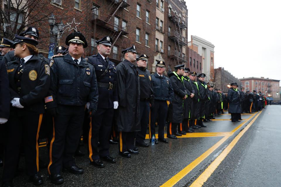 Police officers and other first responders gather before the funeral of Jersey City Police Detective Joseph Seals in Jersey City, N.J., Tuesday, Dec. 17, 2019. Funeral services for Seals are scheduled for Tuesday morning. The 40-year-old married father of five was killed in a confrontation a week ago with two attackers who then drove to a kosher market and killed three people inside before dying in a lengthy shootout with police. (AP Photo/Seth Wenig)