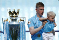 <p>Soccer Football – Premier League – Manchester City vs Huddersfield Town – Etihad Stadium, Manchester, Britain – May 6, 2018 Manchester City’s Kevin De Bruyne celebrates the trophy and family after winning the Premier League title Action Images via Reuters/Carl Recine EDITORIAL USE ONLY. No use with unauthorized audio, video, data, fixture lists, club/league logos or “live” services. Online in-match use limited to 75 images, no video emulation. No use in betting, games or single club/league/player publications. Please contact your account representative for further details. </p>