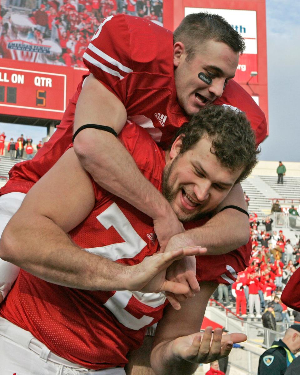Ben Strickland jumps on the back of Joe Thomas during the 5th quarter celebration after the Badgers 35-3 win over Buffalo on Nov. 18, 2006.