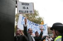 Demontrators protest opposite Downing Street against Prime Minister Narendra Modi's official visit, in London, November 12, 2015. REUTERS/Suzanne Plunkett