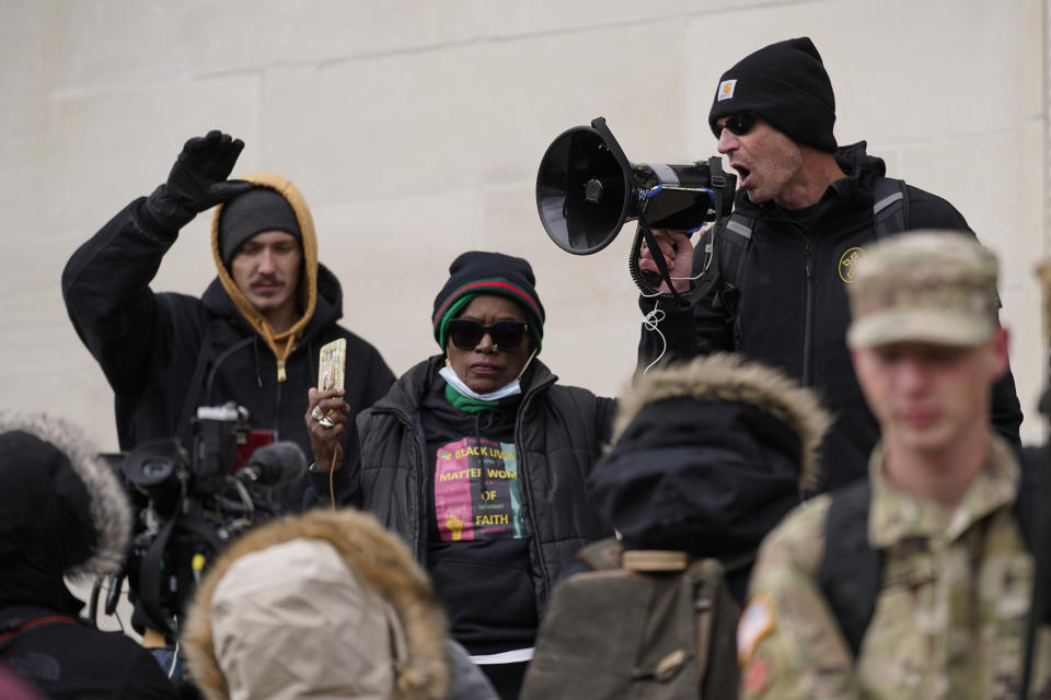 Protesters stand outside the Kenosha County Courthouse, during the Kyle Rittenhouse murder trial, Thursday, Nov. 18, 2021 in Kenosha, Wis. Rittenhouse is accused of killing two people and wounding a third during a protest over police brutality in Kenosha, last year. (AP Photo/Paul Sancya)