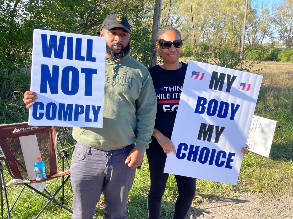 FCI Pekin employees Mario Young (left) and Nekeya Sylvester (right) protest the vaccine mandate for federal employees during Monday's demonstration.