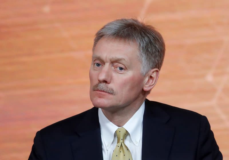 Kremlin spokesman Dmitry Peskov listens during Russian President Vladimir Putin's annual end-of-year news conference in Moscow