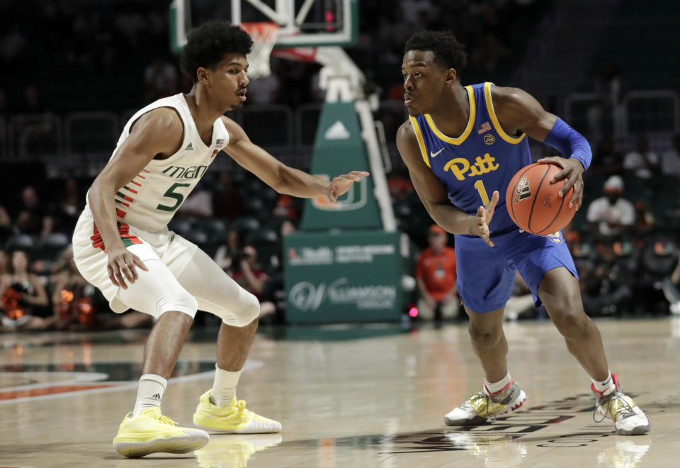 Pittsburgh guard Xavier Johnson (1) drives as Miami guard Harlond Beverly (5) defends during the first half of an NCAA college basketball game, Sunday, Jan. 12, 2020, in Coral Gables, Fla. (AP Photo/Lynne Sladky)