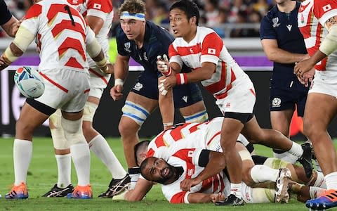 Japan's scrum-half Yutaka Nagare (C) passes the ball during the Japan 2019 Rugby World Cup Pool A match between Japan and Scotland at the International Stadium Yokohama in Yokohama on October 13, 2019 - Credit: AFP