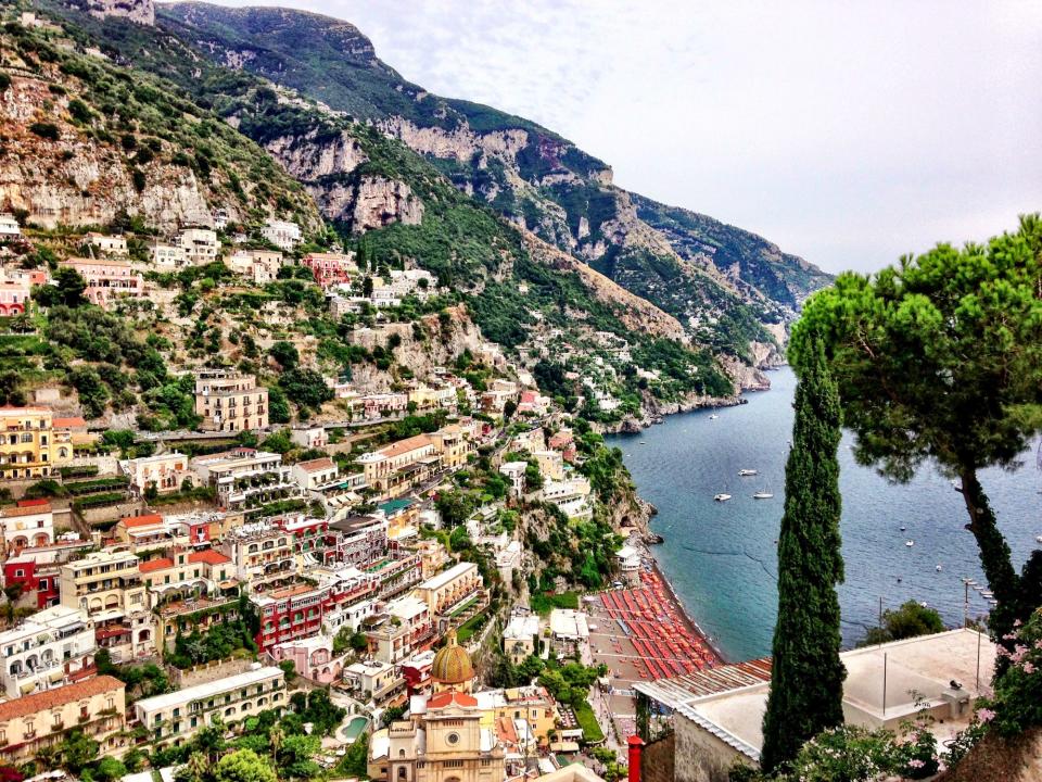 An aerial view of houses and buildings on a hill in Positano, Italy.