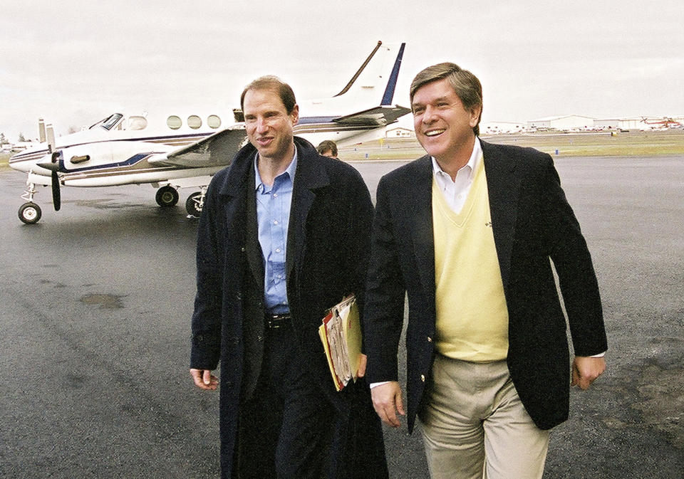 FILE - Sen. Ron Wyden, D-Ore., left, and Sen. Gordon Smith, R-Ore., right, get off a plane Tuesday, Jan. 11, 2005, in Medford, Ore., where they held another joint town hall meeting with voters. Oregon's reputation for political harmony is being tested as a Republican walkout in the state Senate continues for a third week. The boycott could derail hundreds of bills and approval of a biennial state budget, as Republicans and Democrats refuse to budge on their conflicting positions over issues including abortion rights, transgender health and guns. (AP Photo by Jeff Barnard, File)