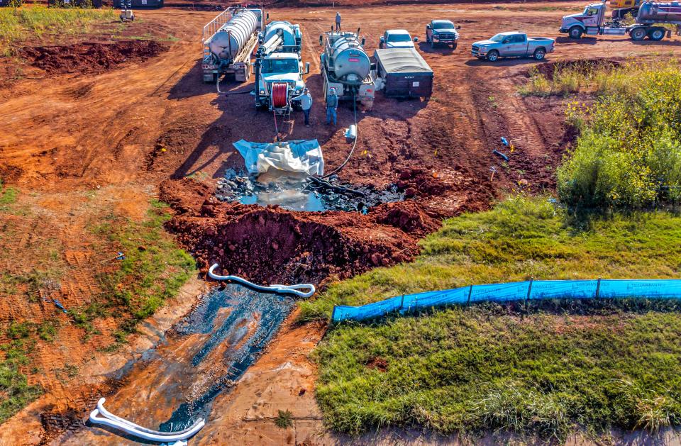 Workers recover crude oil and contaminated soil from a site near NW 184 and Portland Avenue in Oklahoma City on Wednesday.