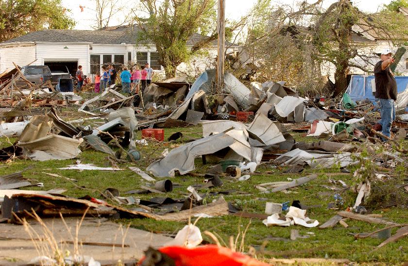 DELETES REFERENCE TO DEATH TOLL - Quapaw, Okla., residents survey the damage in a residential neighborhood struck by a tornado on Sunday evening, April 27, 2014. A powerful storm system rumbled through the central and southern United States on Sunday, spawning a massive tornado that carved path of destruction through the northern Little Rock suburbs and another twister that hit in Oklahoma. (AP Photo/Tulsa World, Gary Crow) KOTV OUT; KJRH OUT; KTUL OUT; KOKI OUT; KQCW OUT; KDOR OUT; TULSA OUT; TULSA ONLINE OUT Gary Crow / For the Tulsa World