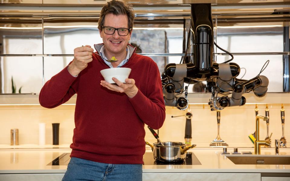 William Sitwell prepares to tuck into his robot-prepped meal - Jeff Gilbert