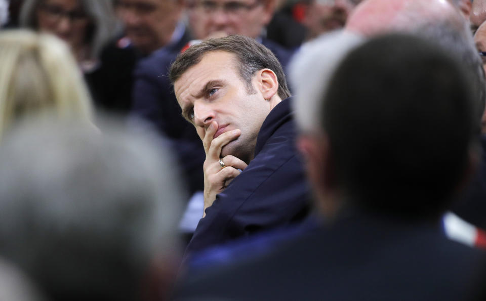 French President Emmanuel Macron attends the "grand debate" with mayors from rural Normandy in Grand Bourgtheroulde, France, Tuesday, Jan.15, 2019. French President Emmanuel Macron encouraged people to express their list of grievances and propose changes to the country's economy during a "grand debate" aimed at appeasing the yellow vest movement, following weeks of anti-government protests. (Philippe Wojazer/Pool Photo via AP)