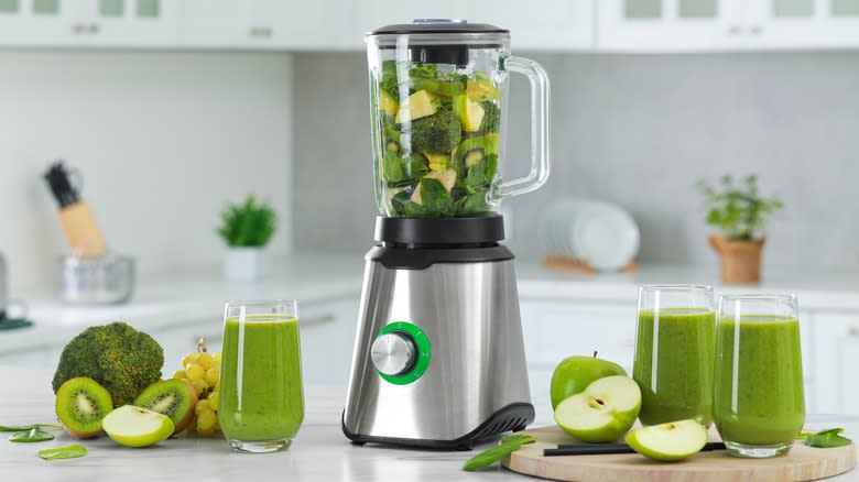 blender over-filled with vegetables