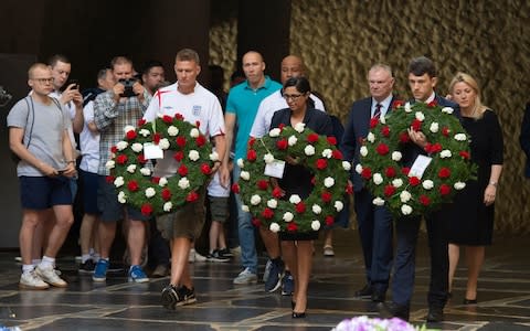 British fans and officials lay wreaths at a war memorial in Volgograd on Monday - Credit: Julian Simmonds/For The Telegraph