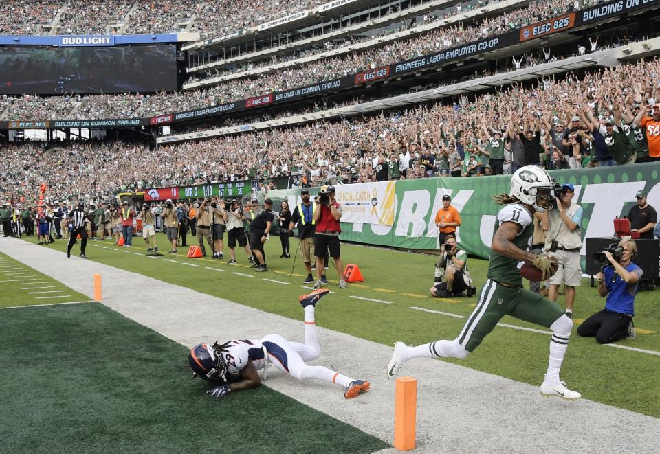 New York Jets wide receiver Robby Anderson (11) runs out of the endzone after catching a pass for a touchdown in front of Denver Broncos' Bradley Roby (29) during the first half of an NFL football game Sunday, Oct. 7, 2018, in East Rutherford, N.J. (AP Photo/Bill Kostroun)