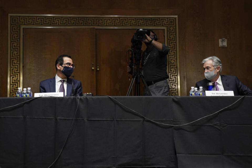 (L-R) US Secretary of the Treasury Steven Mnuchin  and Chairman of the Federal Reserve Jerome Powell testify during the Senate's Committee on Banking, Housing, and Urban Affairs hearing examining the quarterly CARES Act report to Congress on September 24, 2020, in Washington, DC. (Photo by Drew Angerer / POOL / AFP) (Photo by DREW ANGERER/POOL/AFP via Getty Images)