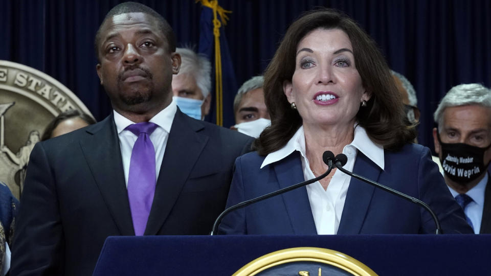 Lt. Gov. Brian Benjamin listens to Gov. Kathy Hochul speak at the podium, with officials wearing masks behind them.speaks during ceremonies in the governor's office, in New York, Sept. 17, 2021. (Richard Drew/AP Photo)