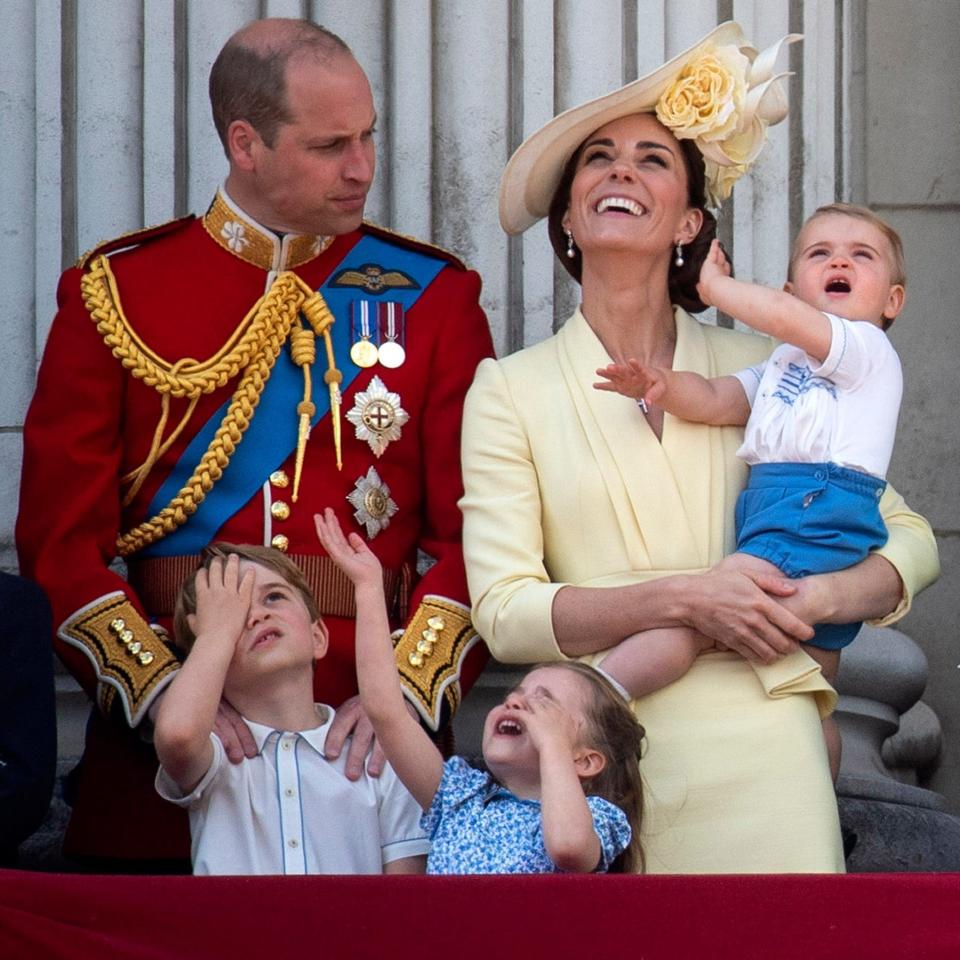 The Duke and Duchess of Cambridge with their children, Prince Louis, Prince George, Princess Charlotte, on the balcony of Buckingham Place in 2019 - PA