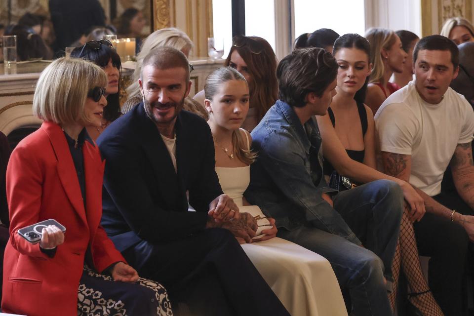 Anna Wintour, from left, David Beckham, Harper Beckham, Cruz Beckham, Nicola Peltz and Brooklyn Beckham attend the Victoria Beckham Spring/Summer 2024 womenswear fashion collection presented Friday, Sept. 29, 2023 in Paris. (AP Photo/Vianney Le Caer)