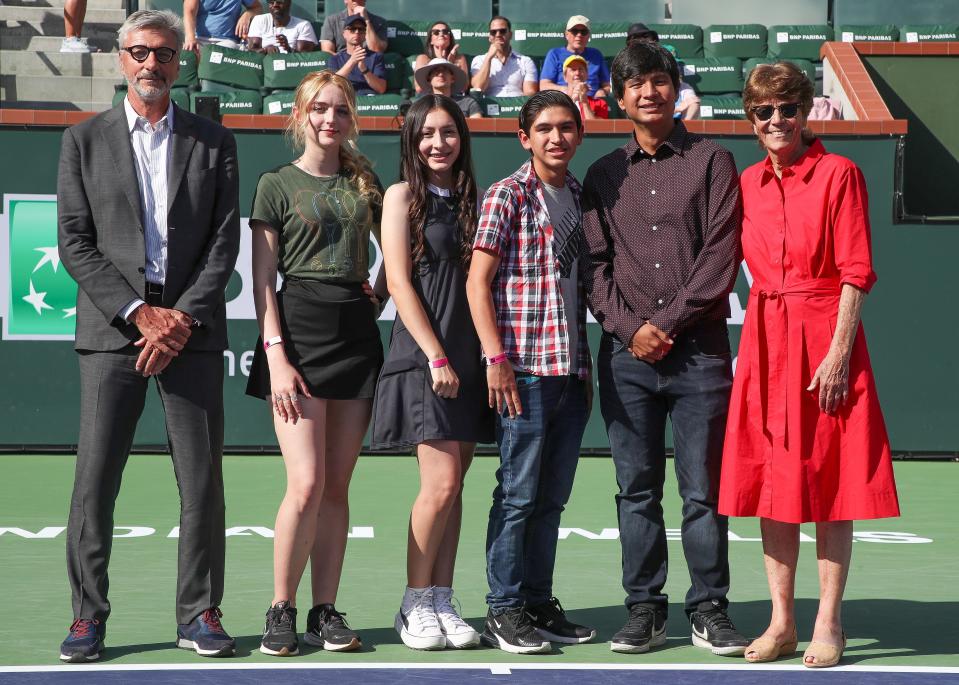 From left, Jean-Yves Fillion, Caitlyn Hill, Stephanie De La Rosa, Jose Hernandez-Beltran, Daniel Fernandez-Robles and Peggy Michel take a photo on the court during the BNP Paribas Open in Indian Wells, Calif., March 18, 2023.  The Desert Mirage students were awarded with a scholarship during the presentation. 