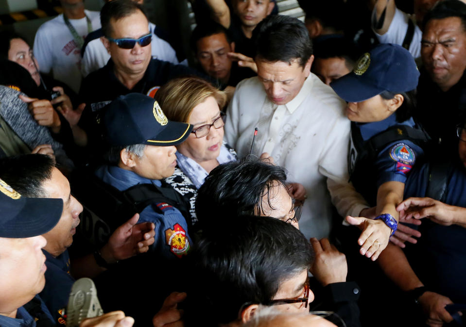 Philippine opposition Sen. Leila de Lima, center, is escorted to her detention a day after a warrant for her arrest was issued by a regional trial court, Friday, Feb. 24, 2017, in suburban Pasay city, south of Manila, Philippines. De Lima was arrested Friday on drug charges but professed her innocence and vowed she would not be intimidated by a leader she called a "serial killer." (AP Photo/Bullit Marquez)