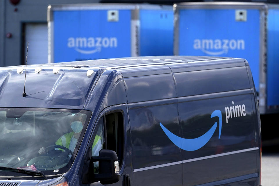 FILE - In this Oct. 1, 2020, file photo, an Amazon Prime logo appears on the side of a delivery van as it departs an Amazon Warehouse location in Dedham, Mass. Amazon announced Tuesday, Feb. 2, 2021, that Jeff Bezos would step down as CEO later in the year, leaving a role he’s had since founding the company nearly 30 years ago. (AP Photo/Steven Senne, File)