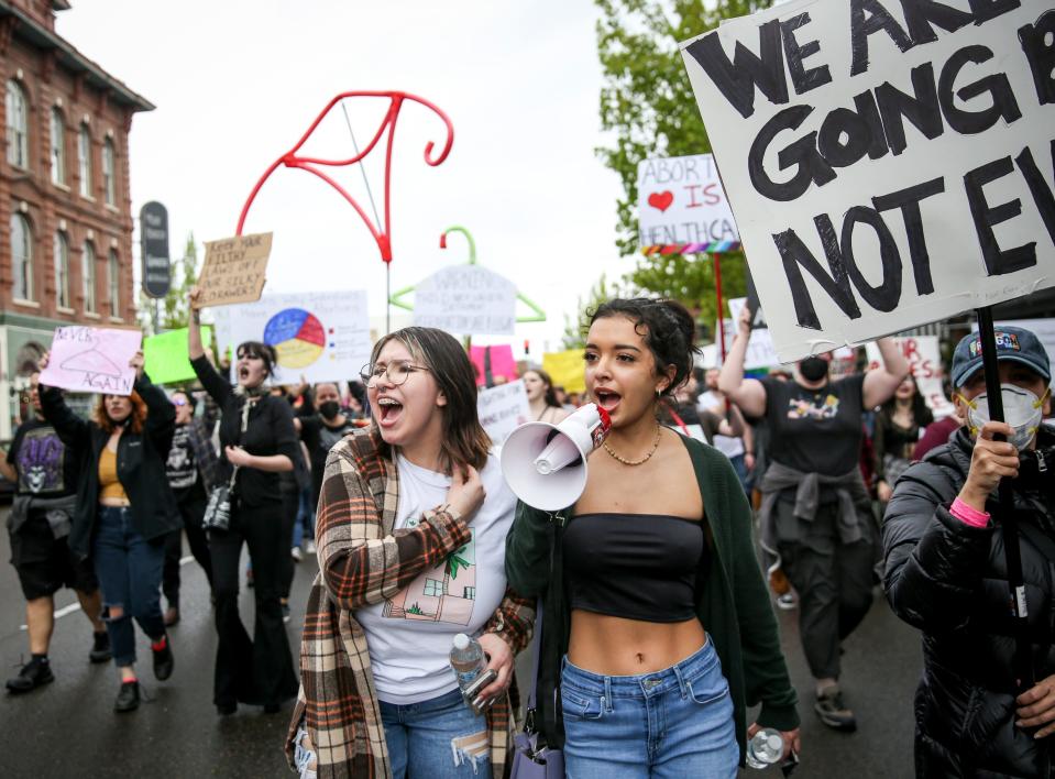 Community members march in defense of abortion rights during the Defend Roe rally on Sunday in Salem.