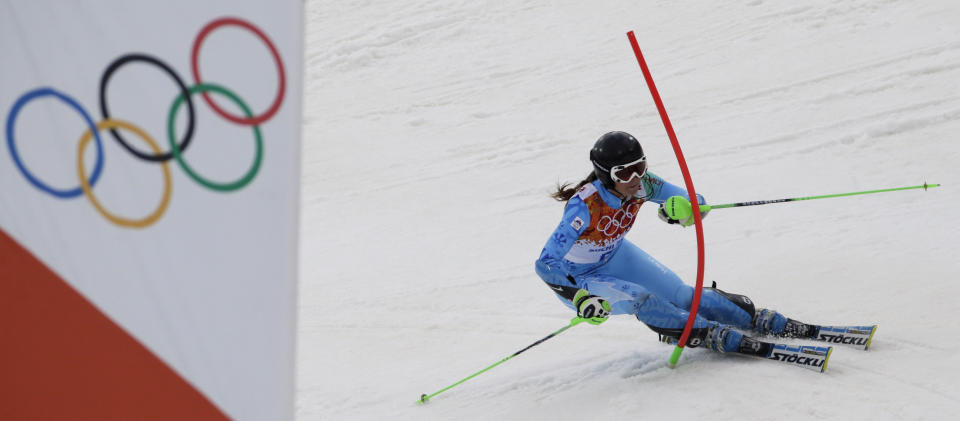 Slovenia's Tina Maze skis past a gate during the women's slalom at the Sochi 2014 Winter Olympics, Friday, Feb. 21, 2014, in Krasnaya Polyana, Russia. (AP Photo/Gero Breloer)