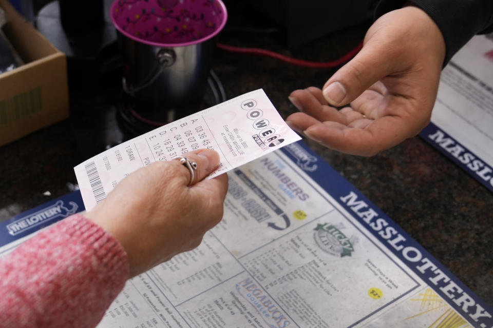 A customer purchases five Powerball tickets at a lottery agent, Tuesday, Oct. 10, 2023, in Haverhill, Mass. After 35 straight drawings without a big winner, Powerball players will have a shot Wednesday at a near-record jackpot worth an estimated $1.73 billion. (AP Photo/Charles Krupa)