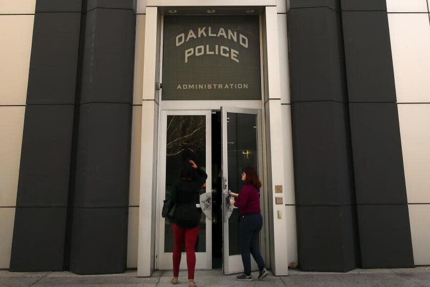 Women enter the Oakland Police building on Wednesday, Jan. 31, 2018, in Oakland, Calif.