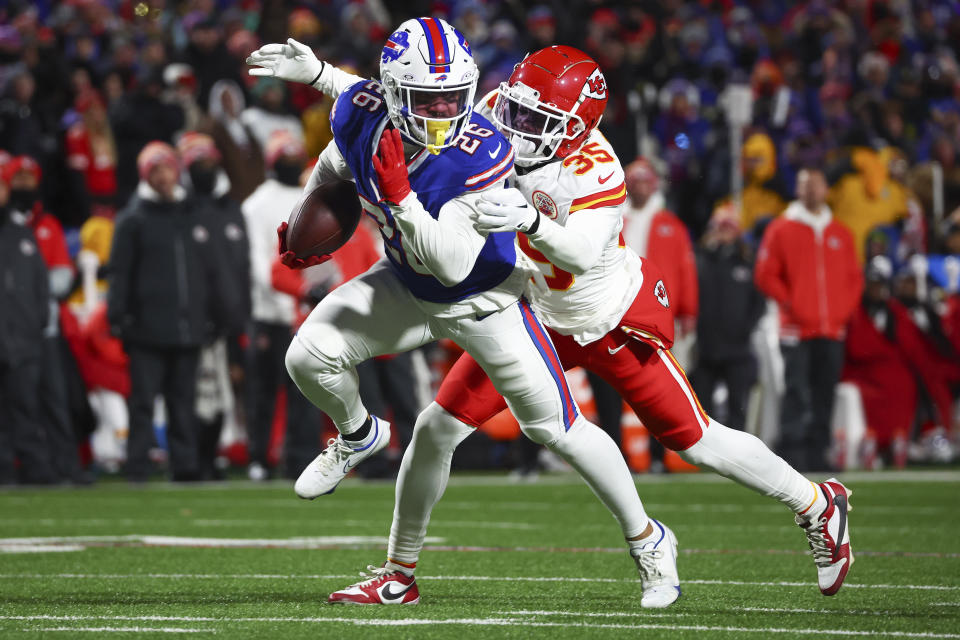 Buffalo Bills running back Ty Johnson (26) carries the ball against Kansas City Chiefs cornerback Jaylen Watson (35) during the third quarter of an NFL AFC division playoff football game, Sunday, Jan. 21, 2024, in Orchard Park, N.Y. (AP Photo/Jeffrey T. Barnes)