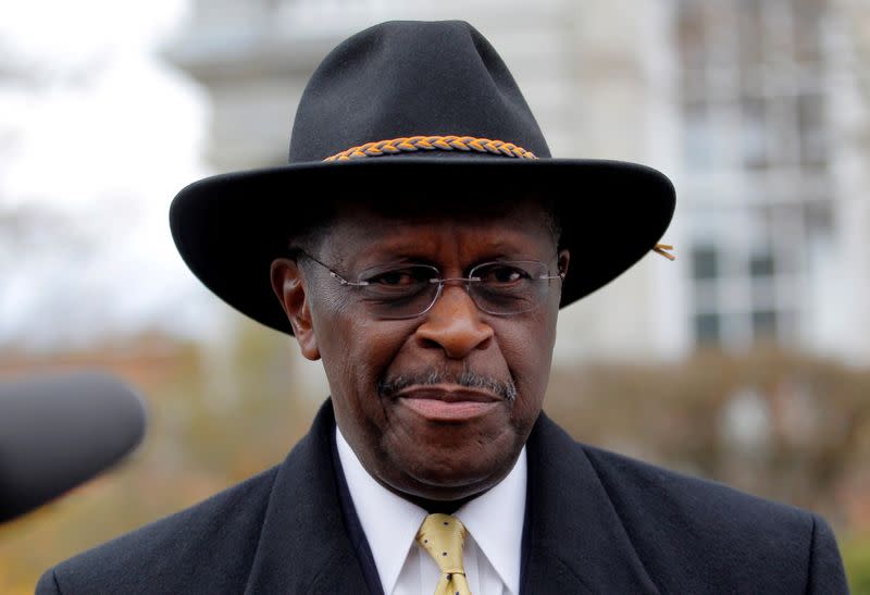 FILE PHOTO: Republican presidential candidate Cain departs the State House in Concord