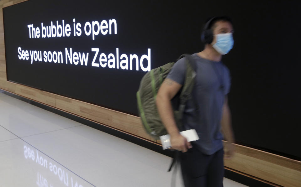 A passenger prepares at Sydney Airport, in Sydney, Australia, Monday, April 19, 2021, to catch a flight to New Zealand as the much-anticipated travel bubble between Australia and New Zealand opens. (AP Photo/Rick Rycroft)