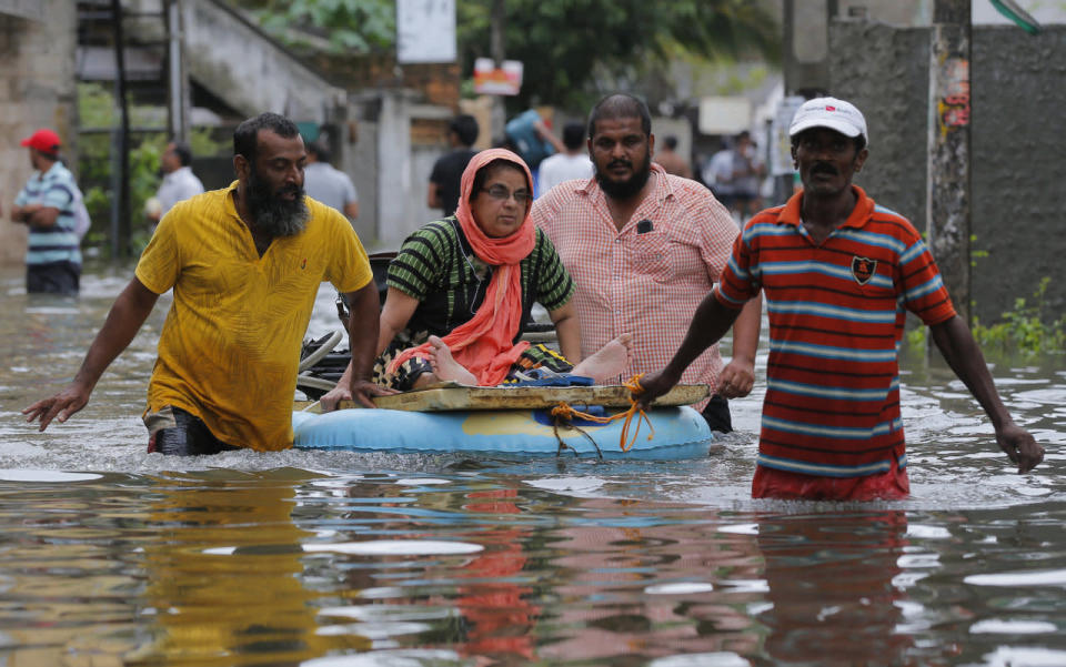 An elderly Sri Lankan woman is moved on a makeshift raft at a flooded area in Colombo, May 17, 2016. (AP Photo/Eranga Jayawardena)