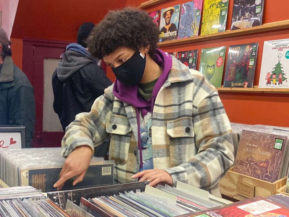 Lezlie Wofford, who grew up in Springfield and now lives and teaches in Kansas City, flips through some vinyl records at Dumb Records in Springfield on Friday morning. The independent store was marking Black Friday Record Day, along with Recycled Records, which is also downtown.