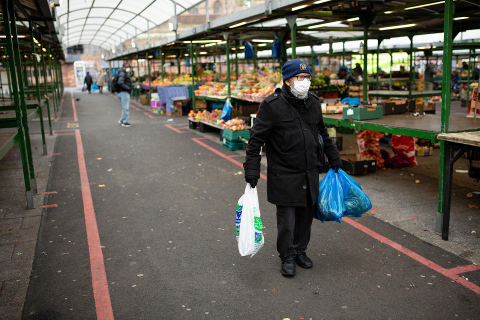 A shopper at a quiet market in Birmingham on Wednesday. MPs have retrospectively approved Boris Johnson's coronavirus lockdown for England. (Jacob King/PA)